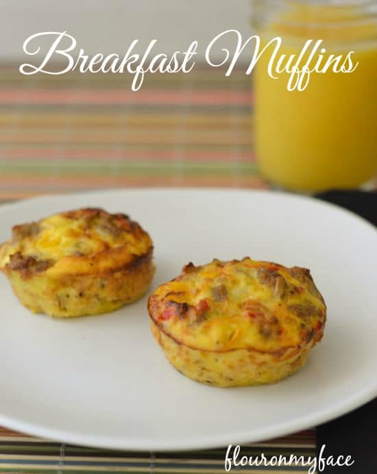 Breakfast-Muffins on a white plate next to a glass of orange juice