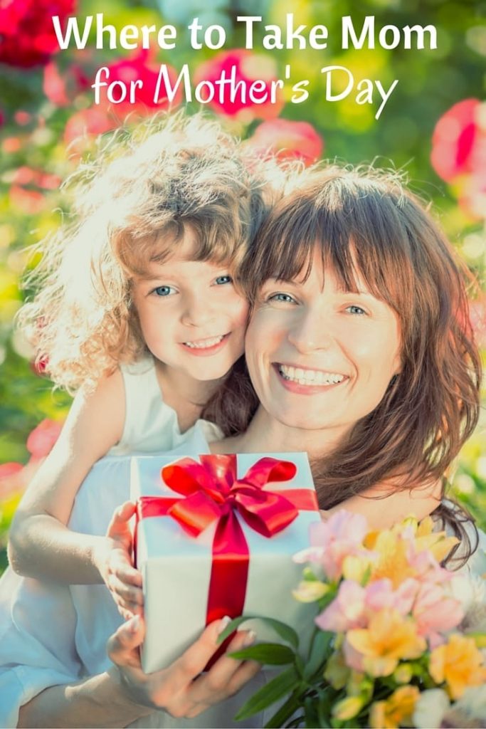 a daughter on her mom's back and her mom is holding a present while standing outside near flowers with title text reading Where to take mom for Mother's Day