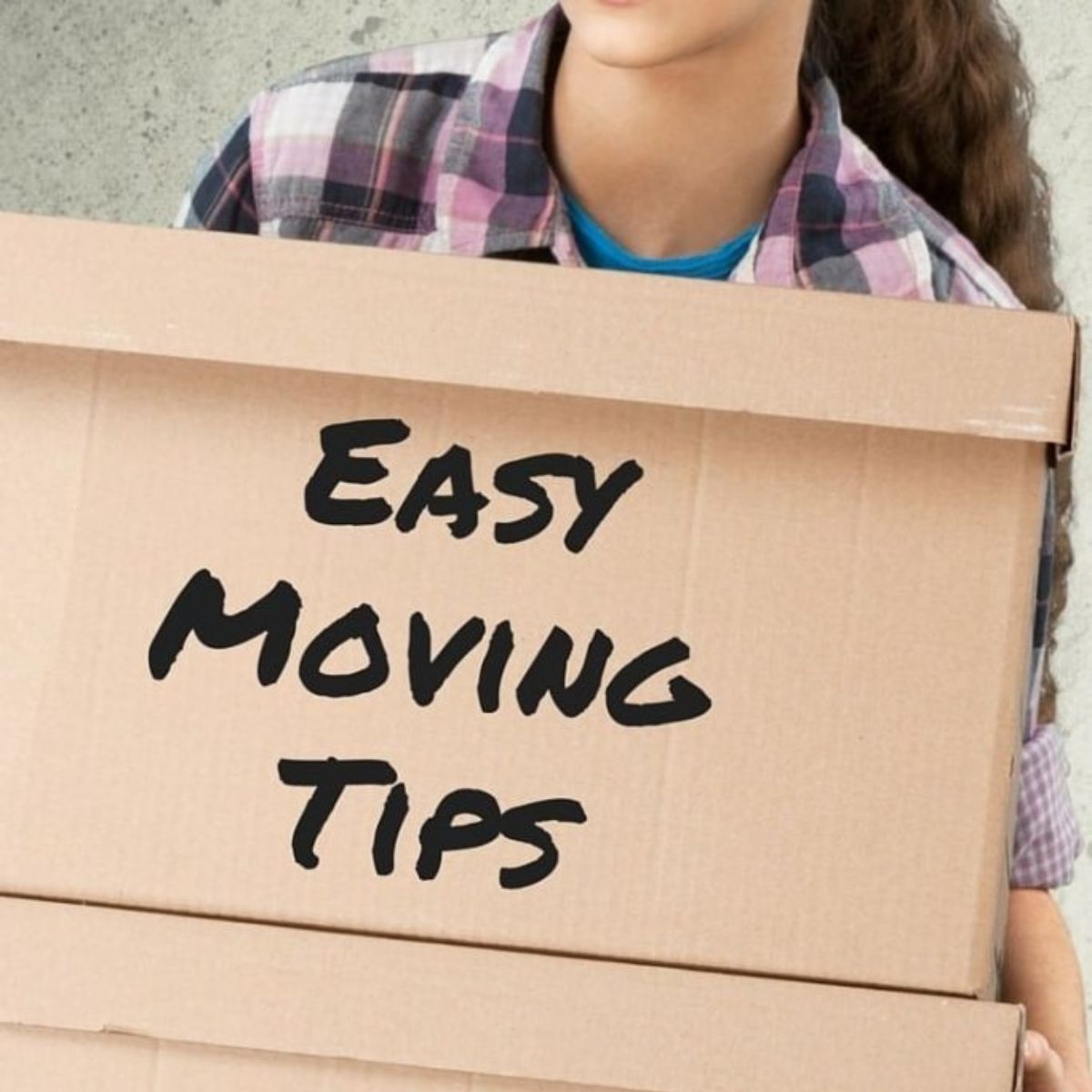 A person holds cardboard boxes, with “Easy Moving Tips” boldly printed on the front box, ready to share practical advice for a smoother move.