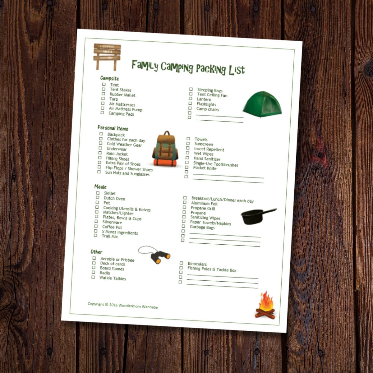A printed family camping packing list with categorized checkboxes for campfire, personal items, meals, and other essentials is placed on a wooden surface.