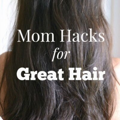 A person with long, straight brown hair is shown from behind, highlighting simple mom hacks for great hair with the text "Mom Hacks for Great Hair" overlaid on the image.