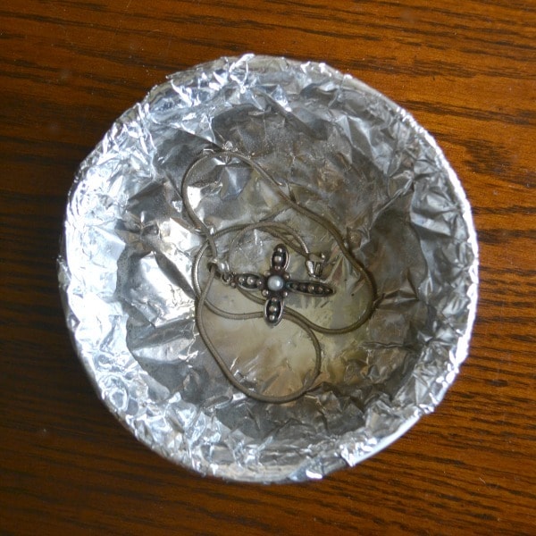 Make your own jewelry cleaner with foil, hot water, and baking soda