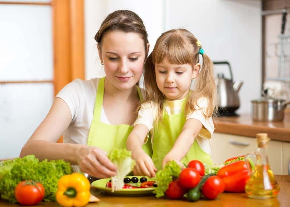 a mom and daughter preparing vegetables as part of their Back to School Routines 