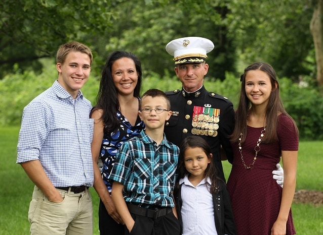 my family - two sons, two daughters, my husband in his Marine uniform, and myself all outside 