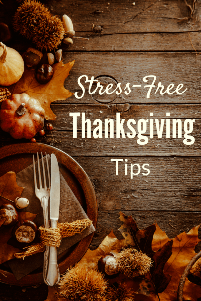 pumpkins, leaves, gourds, nuts and other Fall decor on a brown wood table with title text reading  stress-free Thanksgiving tips.