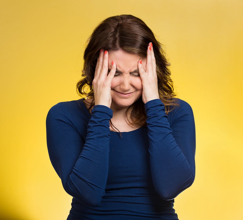 Closeup portrait middle aged stressed woman having so many thoughts, worried about future, thinking, isolated yellow background. Human facial expressions, feelings, emotions, attitude, life perception
