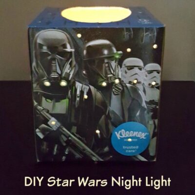 A Star Wars night light is crafted from a Kleenex box featuring Star Wars characters, with small holes letting light shine through and the text "DIY Star Wars Night Light" below.