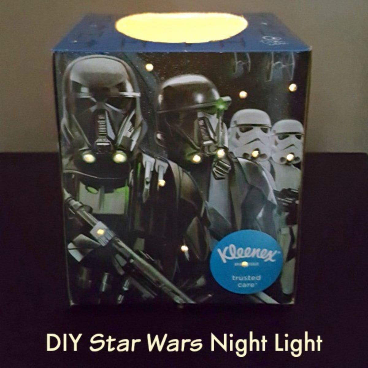 A Star Wars night light is crafted from a Kleenex box featuring Star Wars characters, with small holes letting light shine through and the text "DIY Star Wars Night Light" below.