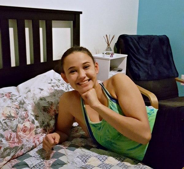 a teen girl laying on a bed