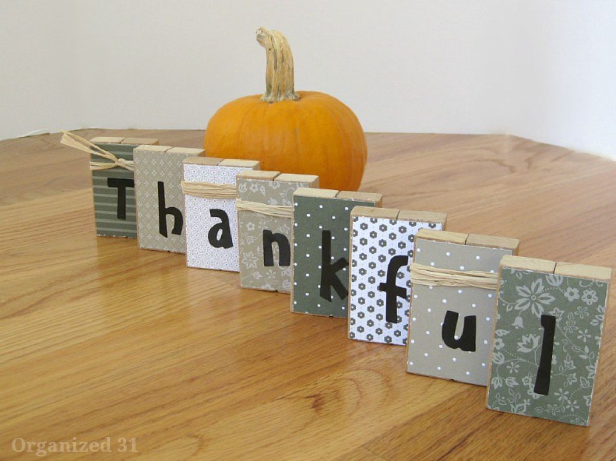 Easy Thanksgiving decor idea: Display a wooden board with the words "thankful" written on it.