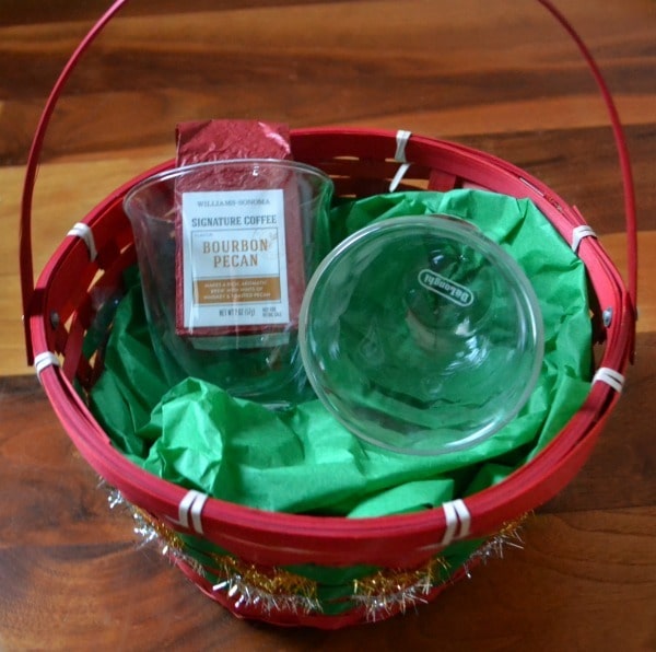 a red basket filled with cups and gourmet coffee