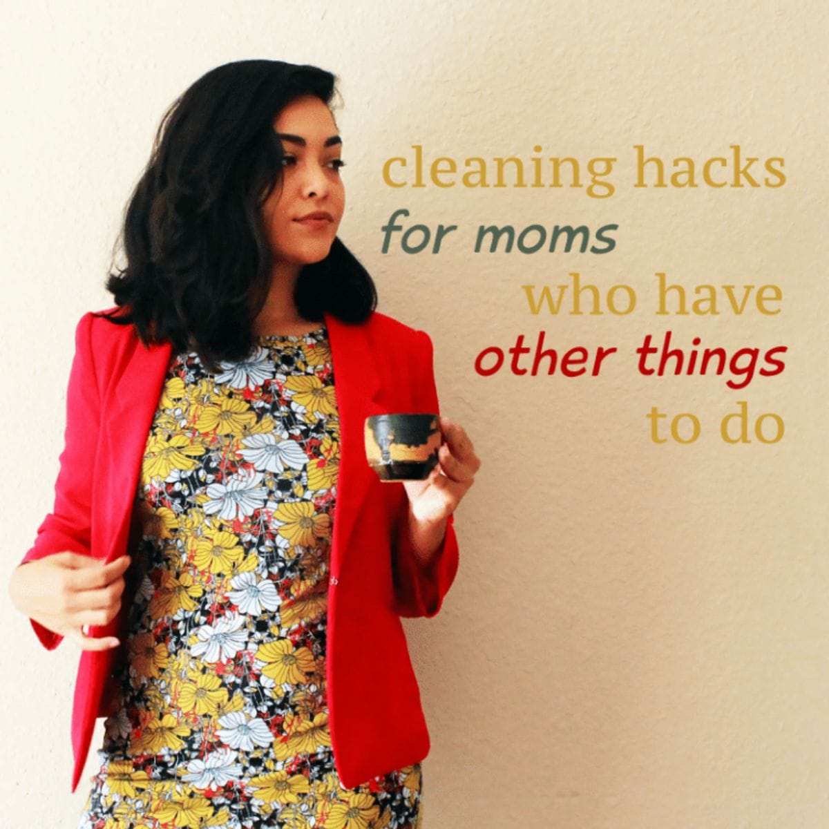 Woman in a floral dress and red blazer holding a cup, with text: "cleaning hacks for moms" on a plain background. Perfect tips for busy moms who want quick and easy solutions for a tidier home.
