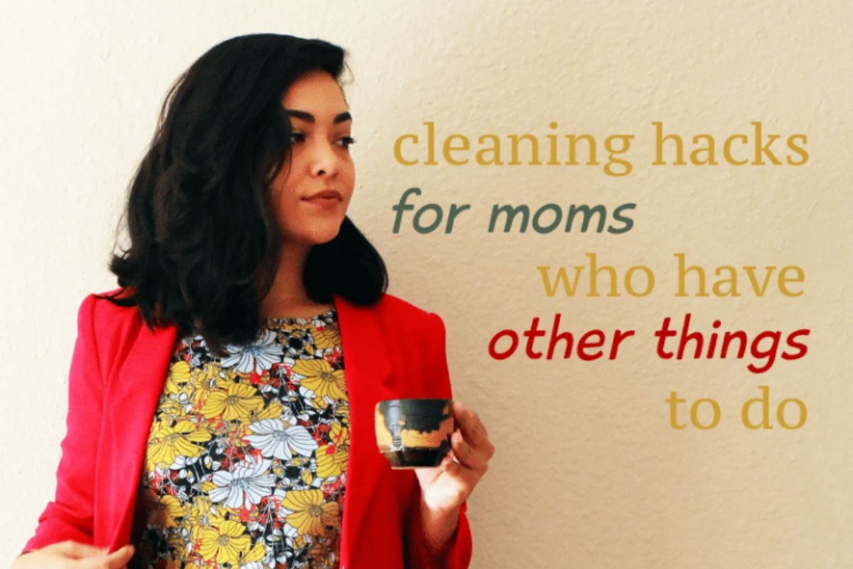 Woman holding a cup, standing in front of a wall with the text: "Cleaning hacks for moms who have other things to do," sharing effortless tips for busy mothers.