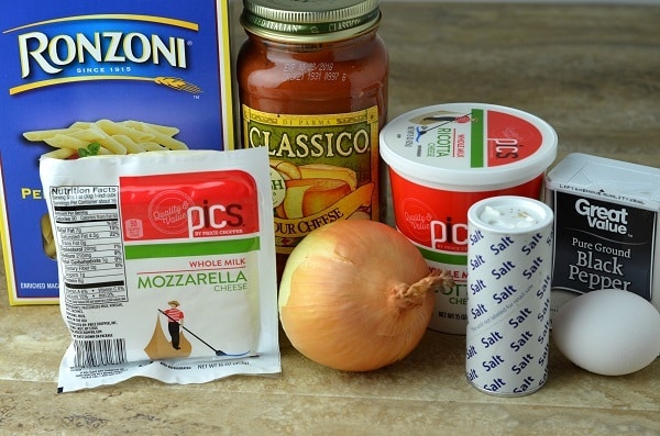 pasta, pasta sauce, ricotta, pepper, mozzarella, onion, salt, egg on a kitchen counter