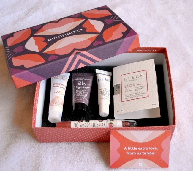 a birchbox with a variety of makeup and skincare items in it on a white background