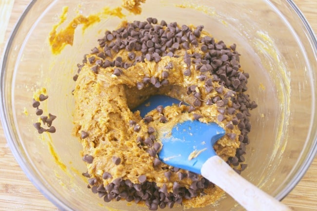 ingredients for No Flour Peanut Butter Protein Cookies in a glass mixing bowl on a brown table