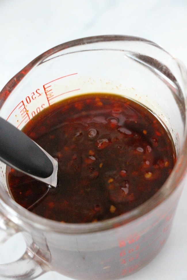 sauce in a glass measuring cup on a white counter