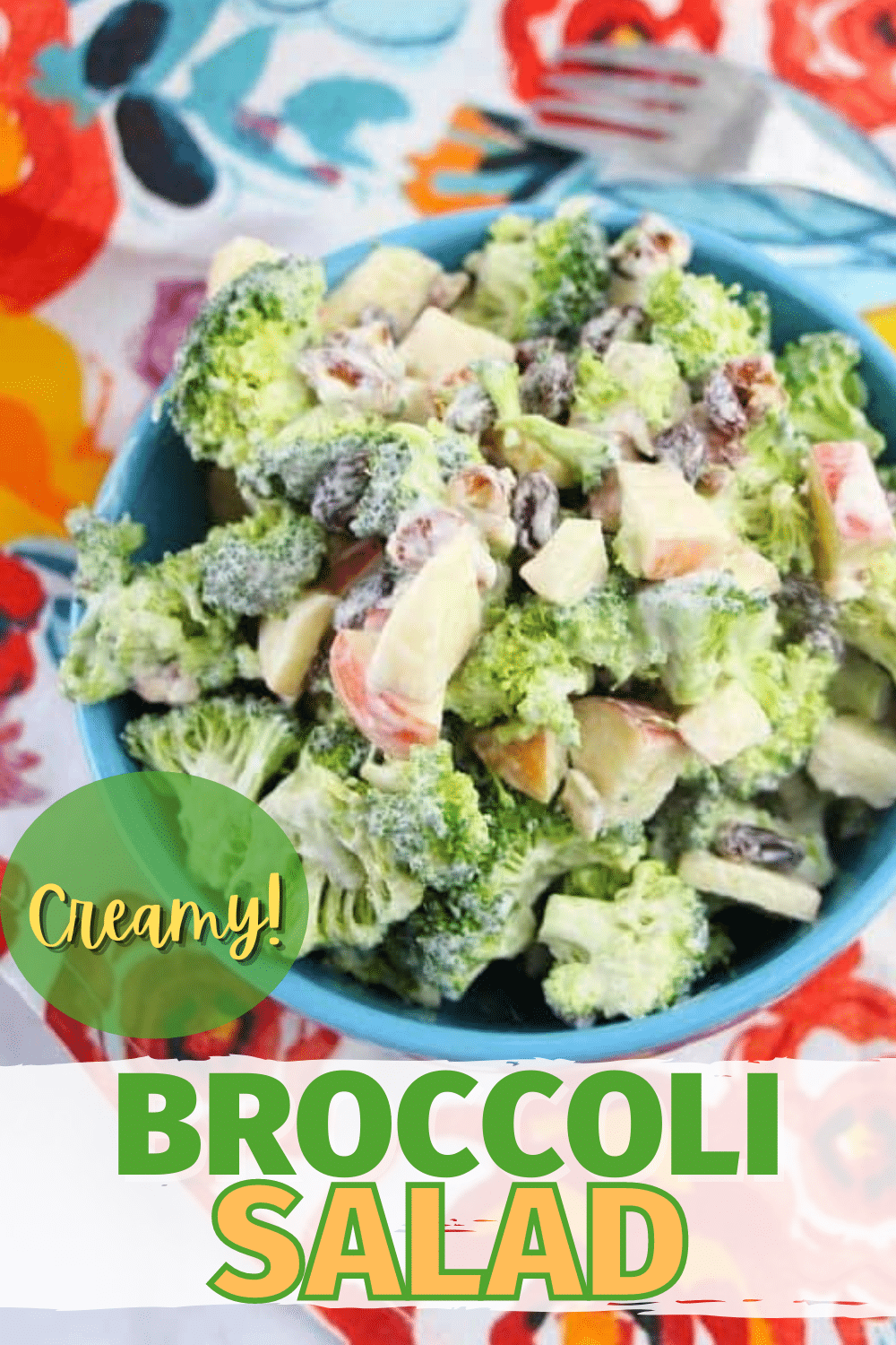 Broccoli Salad in a blue bowl on a flower cloth with title text reading Creamy Broccoli Salad