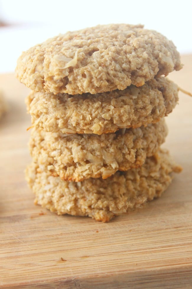 a stack of coconut oatmeal protein cookies on a wooden board