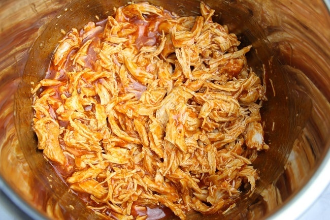 shredded chicken and enchilada sauce in an instant pot