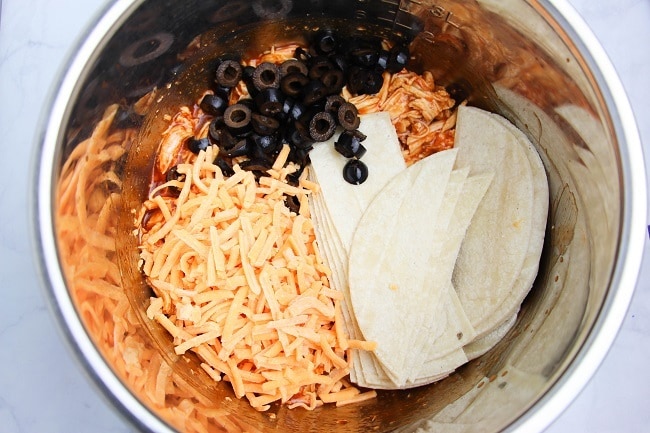 shredded chicken and enchilada sauce, shredded cheese, olives, tortillas in an instant pot
