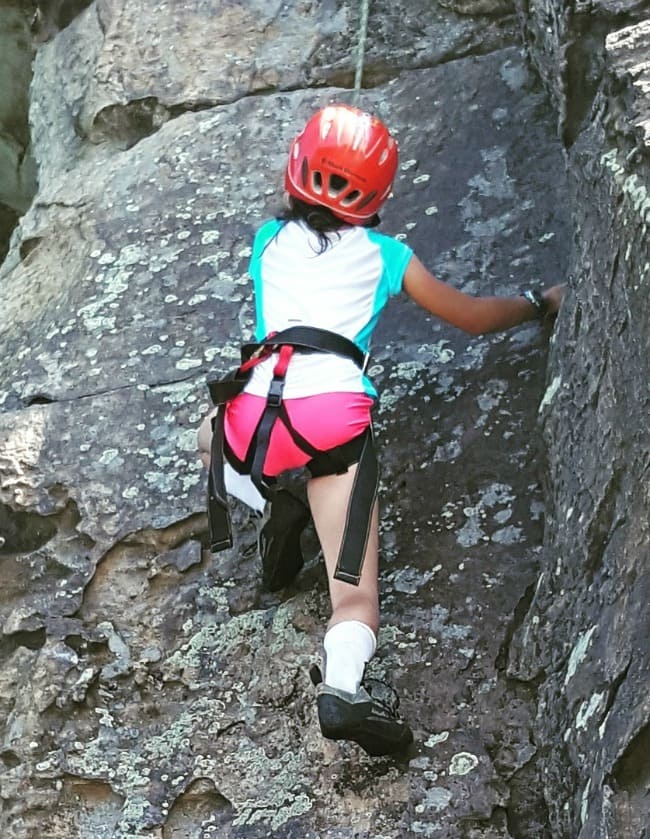 a girl rock climbing