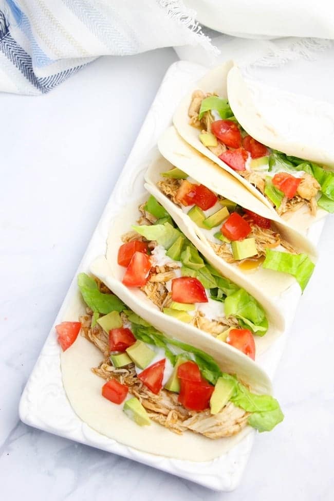 Instant Pot Salsa Verde Chicken Tacos on a white tray on a white counter