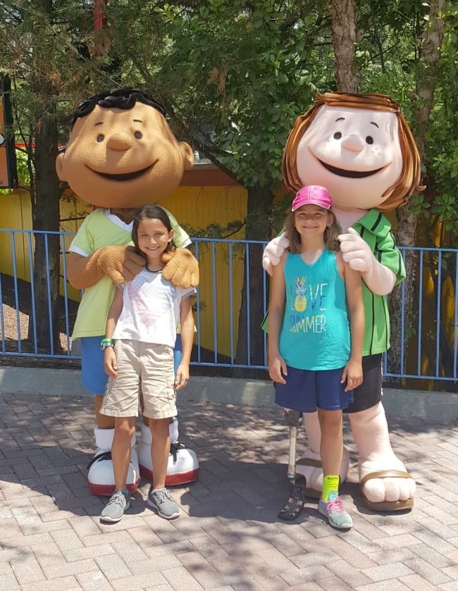 two girls standing with Franklin and Peppermint Patty characters