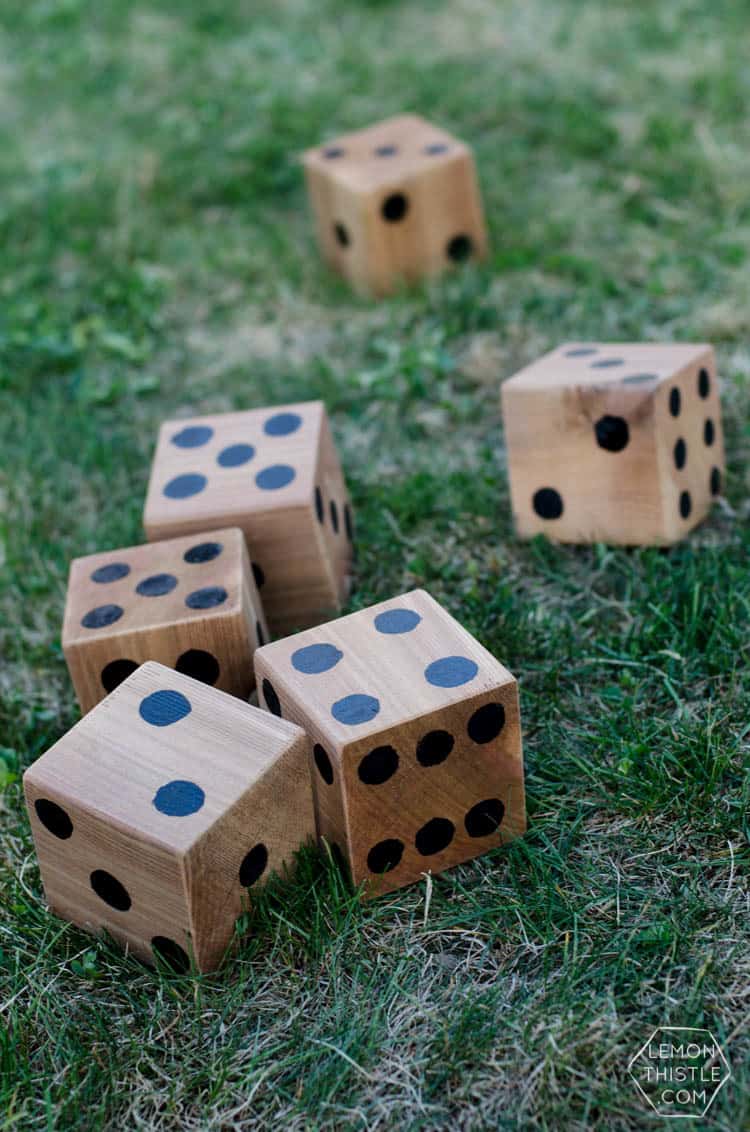 large wooden dice on the grass