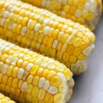 Close-up of several ears of corn on the cob with yellow and white kernels, perfect for making instant pot corn on the cob.