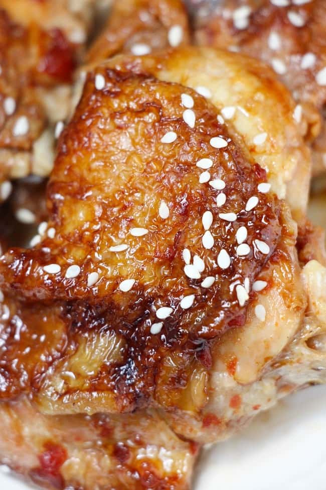 a close up of honey garlic chicken on a white plate