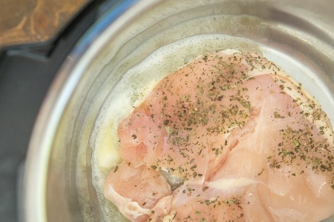 chicken seasoned with thyme, basil, and salt in an instant pot