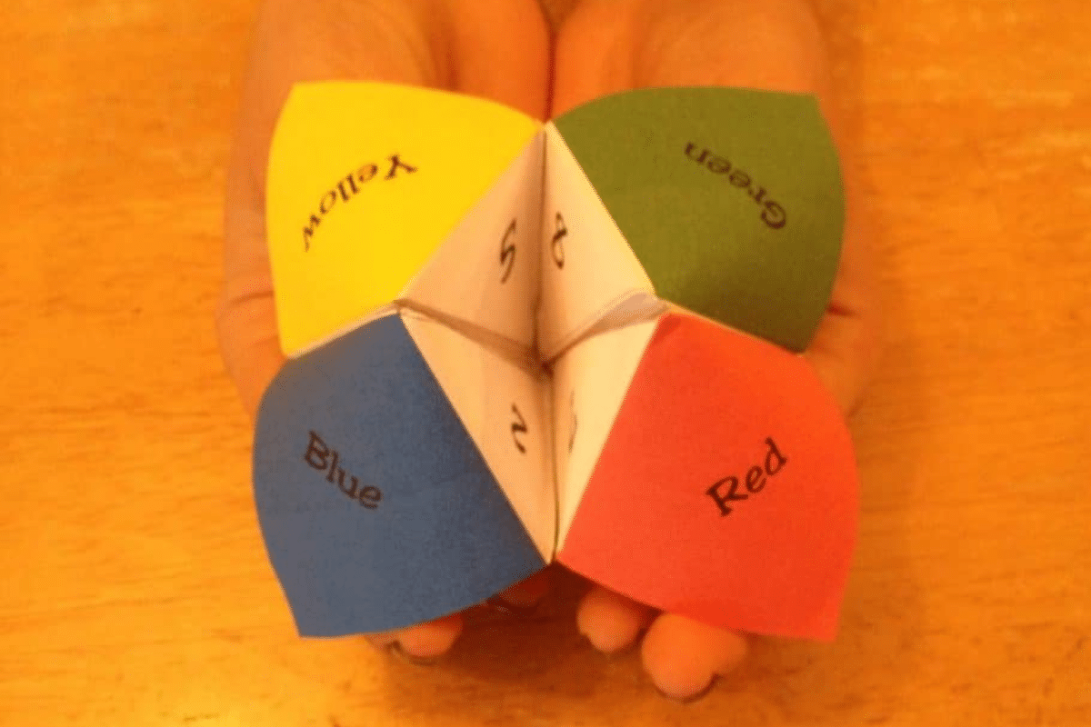 a woman holding cootie catcher.
