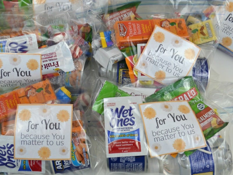 plastic bags filled with snack items, wet ones, and water bottles with a printable card reading for you because you matter to us