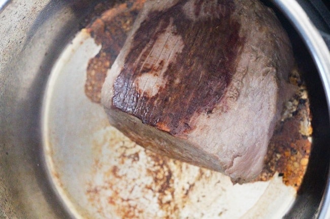 a roast being seared in an instant pot