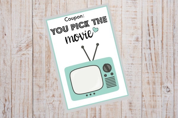 printable you pick the movie coupon on a wood background
