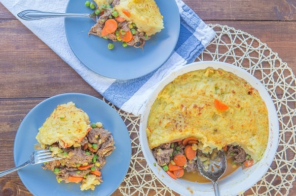 instant pot shepherd's pie in a white dish and on two blue plates with forks on them