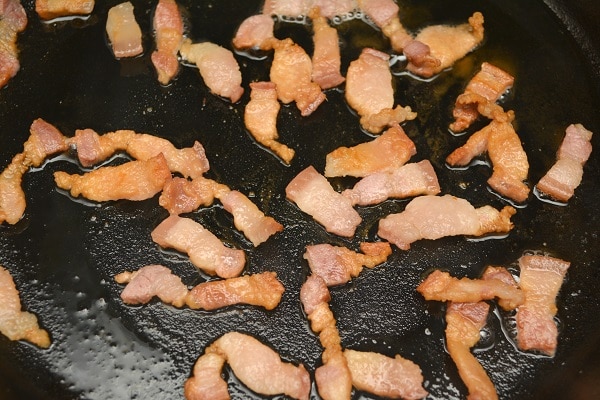 salt pork cooking in a frying pan