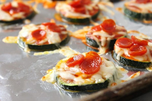 zucchini pizza bites on a foil lined baking sheet
