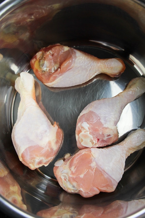 four raw chicken legs in an instant pot
