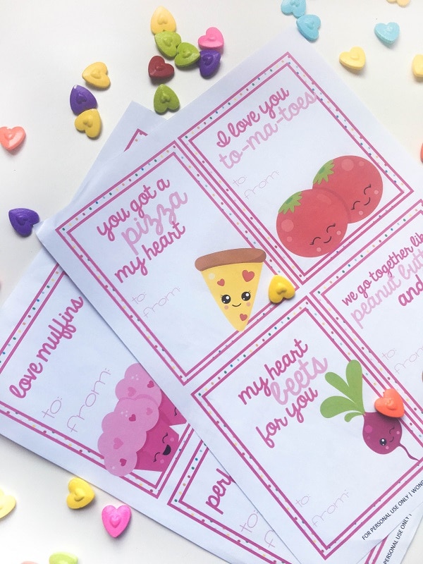 printable valentines surrounded by colored heart candies on a white background