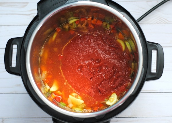 vegetable soup in an instant pot on a white wood table