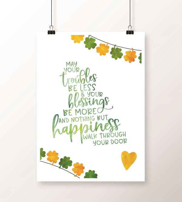 a printable with gold and green shamrocks on the edges with text in the center reading May Your troubles be less and your blessings be more and nothing buy happiness walk through your door