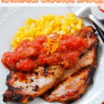 Grilled Pork Chops with Rhubarb Orange Sauce and corn on a white plate