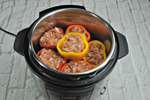 stuffed peppers in an instant pot on a white brick surface