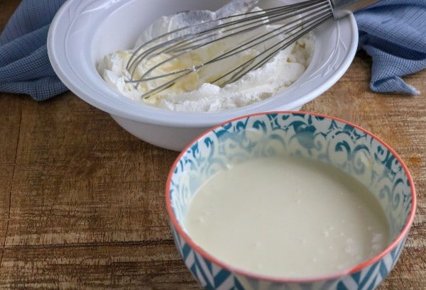 mixing together the sweetened condensed milk and the whipping cream