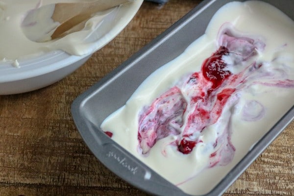 berries mixed into the ice cream mixture in the loaf pan