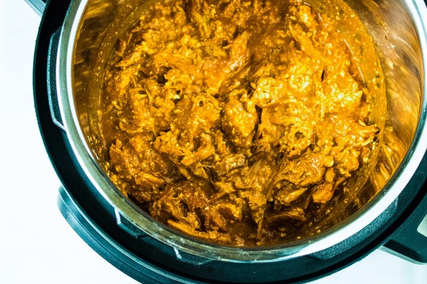 buffalo chicken dip cooking in an instant pot on a white counter