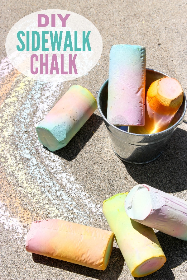 sidewalk chalk on the ground and in a metal can next to a chalk drawing on the ground with title text reading DIY Sidewalk Chalk
