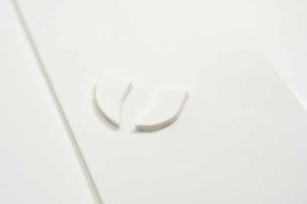 white craft foam cut in the shape of teeth on a white background